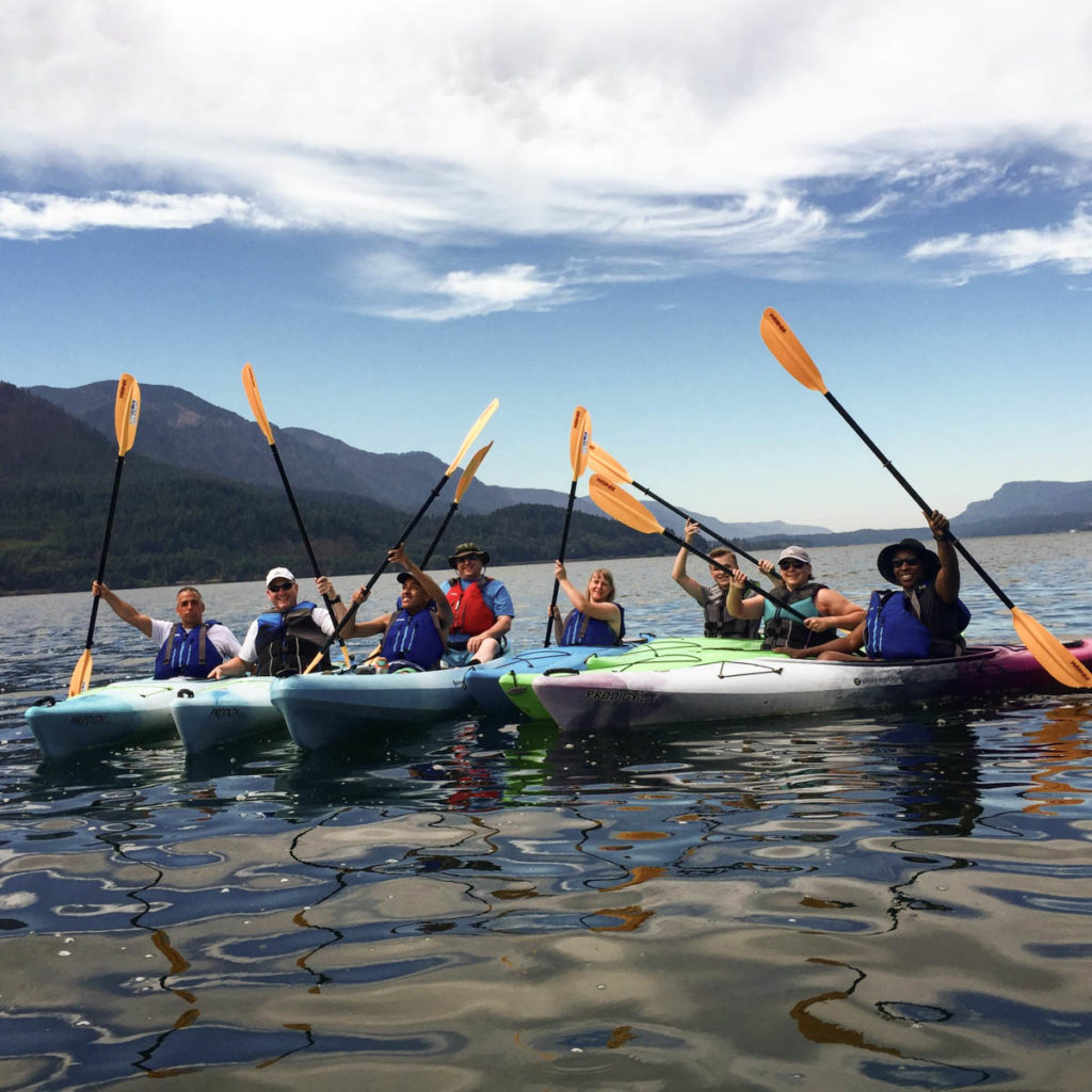 group of paddlers raising their paddled